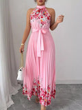 Summer maxi dress featuring a halter neck, floral print, and pleated design in pink, perfect for warm-weather outings.