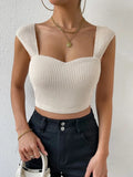 Waffle knit tank top in cream color, featuring a fitted design and thick straps, perfect for layering and casual wear.