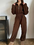 Stylish model wearing a women's jumpsuit zip front long sleeve in brown, showcasing a casual and trendy look.