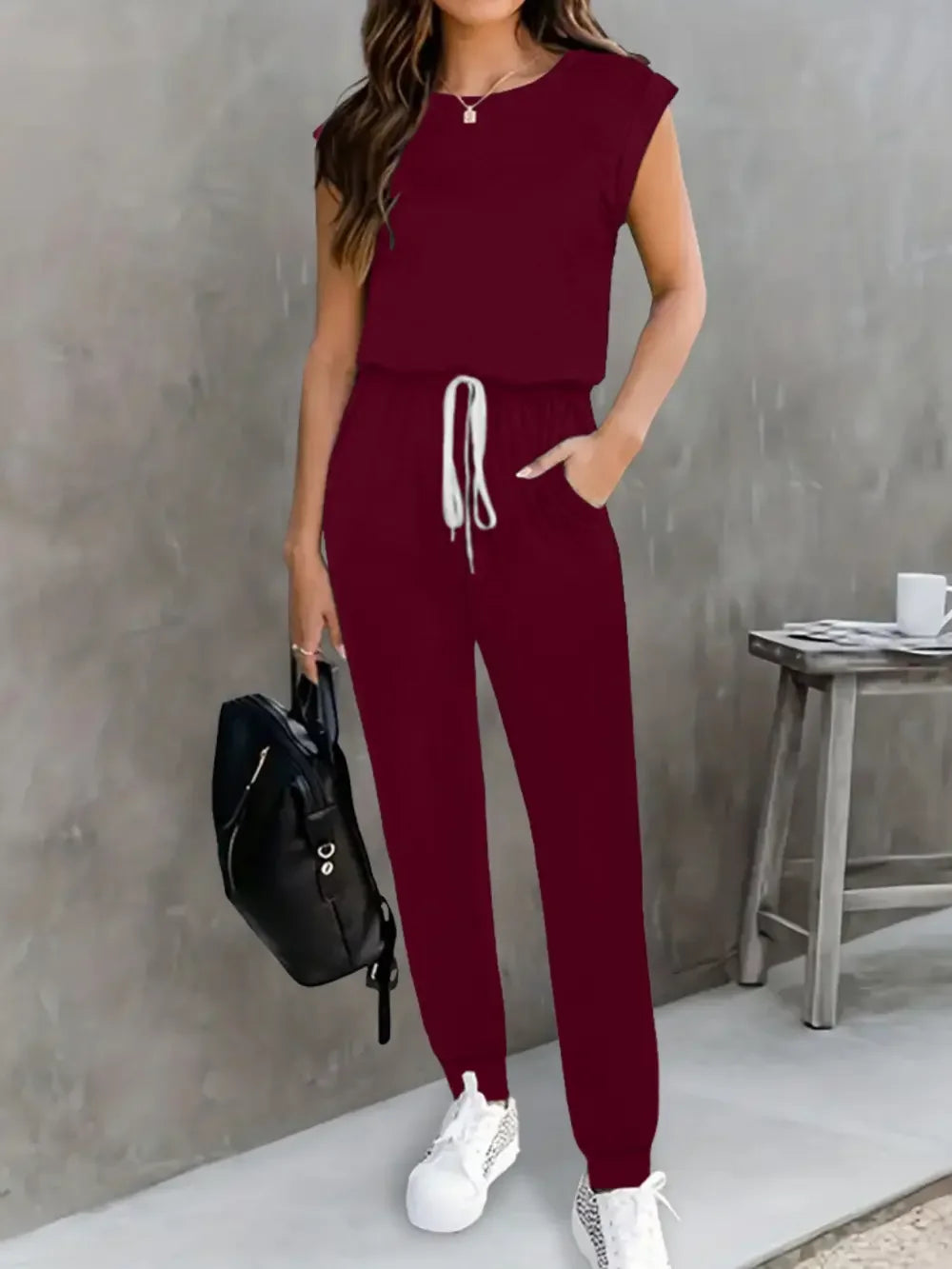 EmpowerEase Sleeveless Drawstring Jumpsuit in burgundy, stylish and comfortable for women's casual wear.