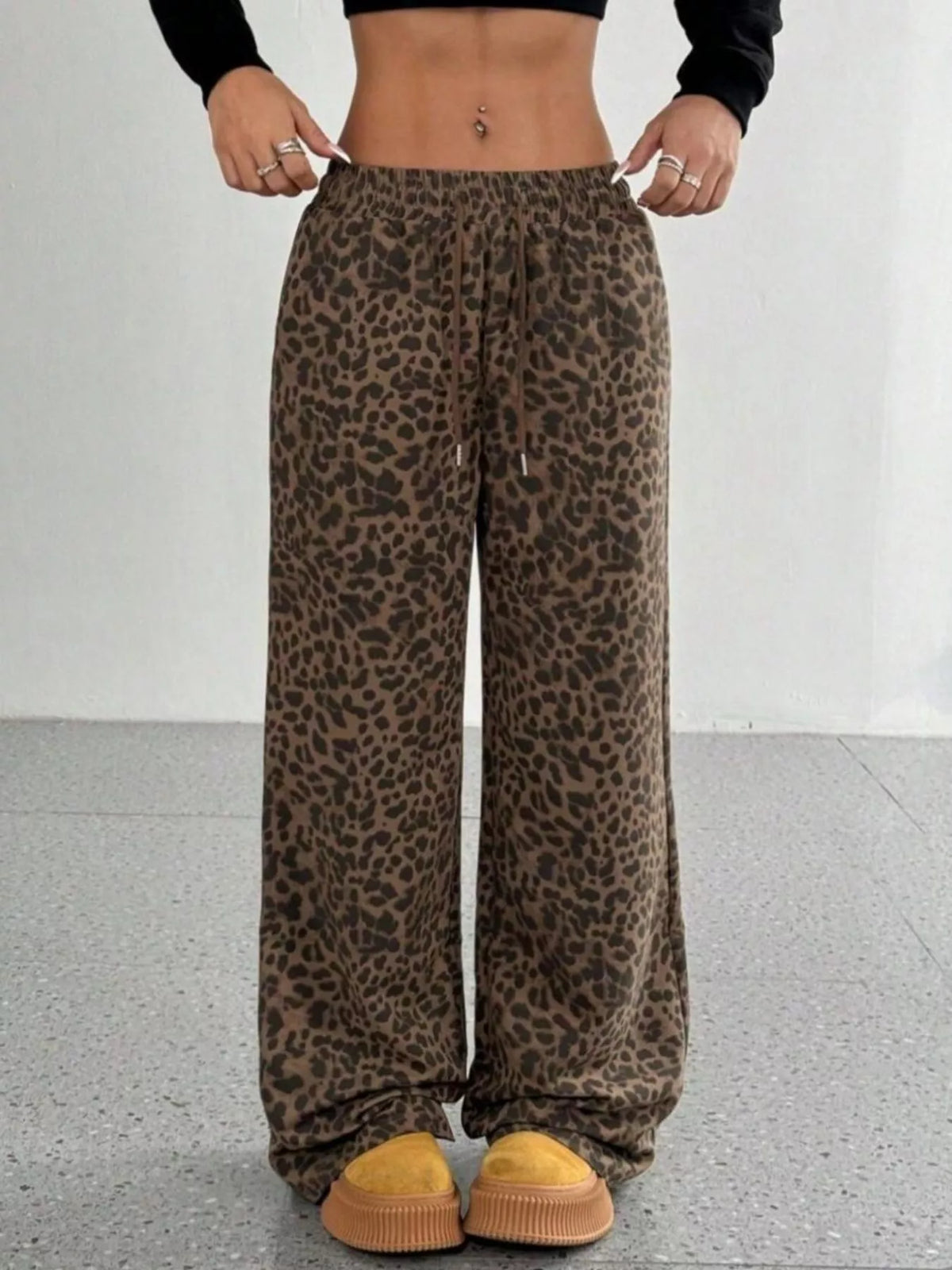 Leopard Drawstring Wide Leg Pants worn with a black long-sleeve top, featuring a stylish design and comfortable fit.