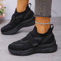 Black mesh sneakers with round toe design, featuring a stylish strap and breathable upper for comfort.
