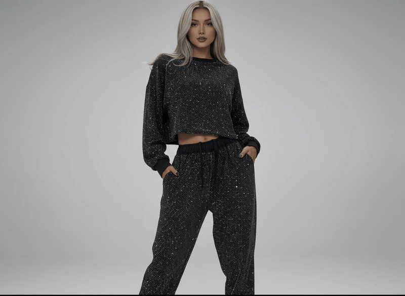 Model wearing a rhinestone two-piece set featuring a long sleeve top and pants with a stylish drawstring.