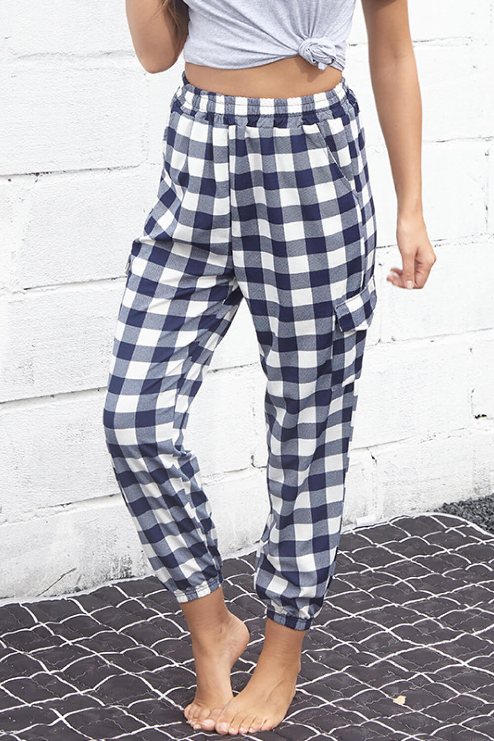 Fashionable cargo pants in plaid pattern with elastic high waist, perfect for casual outings.