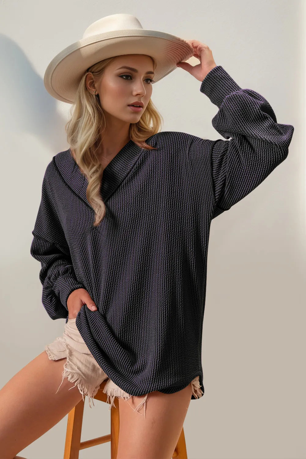 Double Take Exposed Seam Ribbed Textured V-Neck Long Sleeve T-Shirt in stylish casual look with hat and shorts.