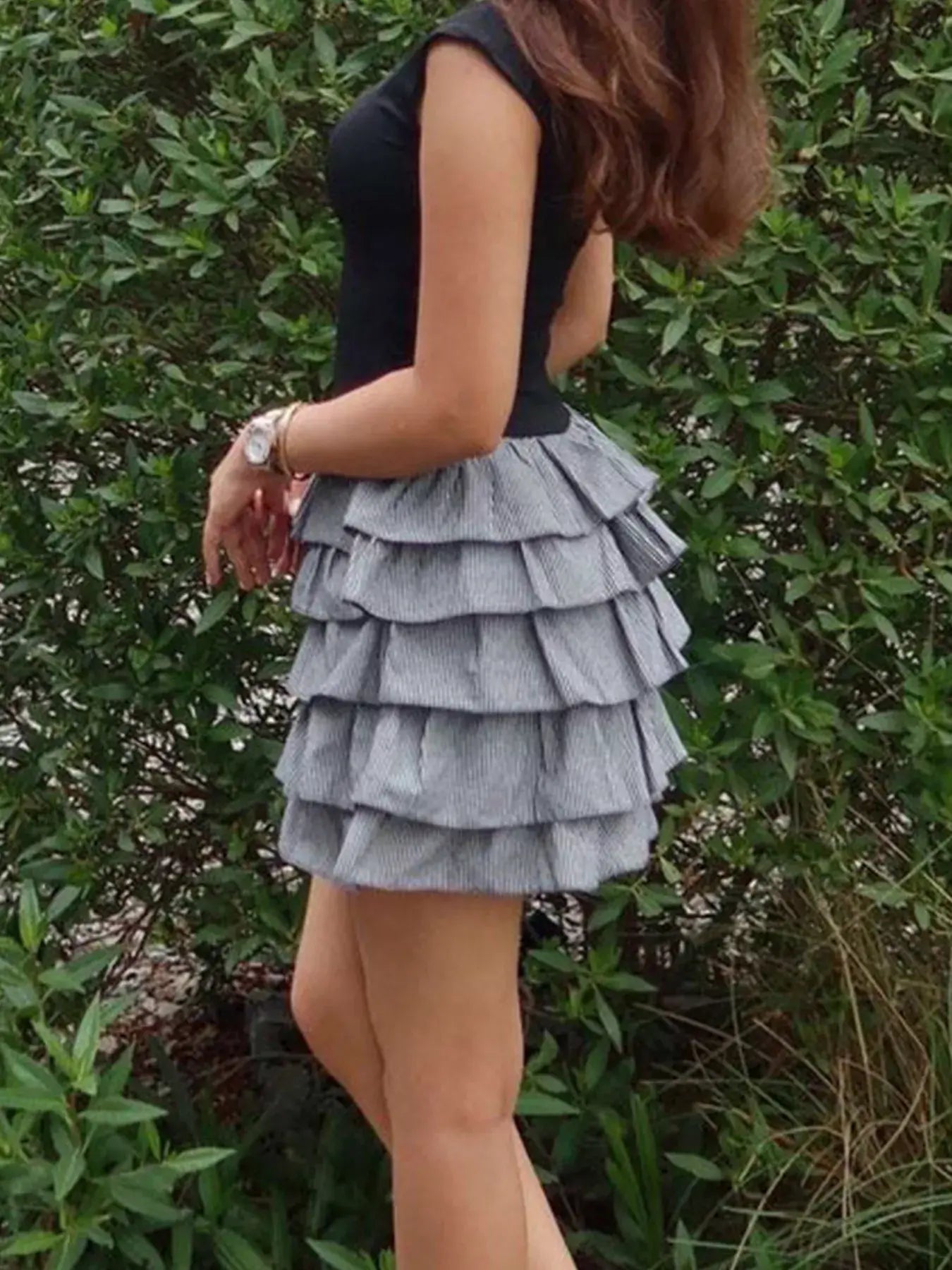 Ruffle mini dress layered with playful tiers, perfect for casual outings and special occasions.