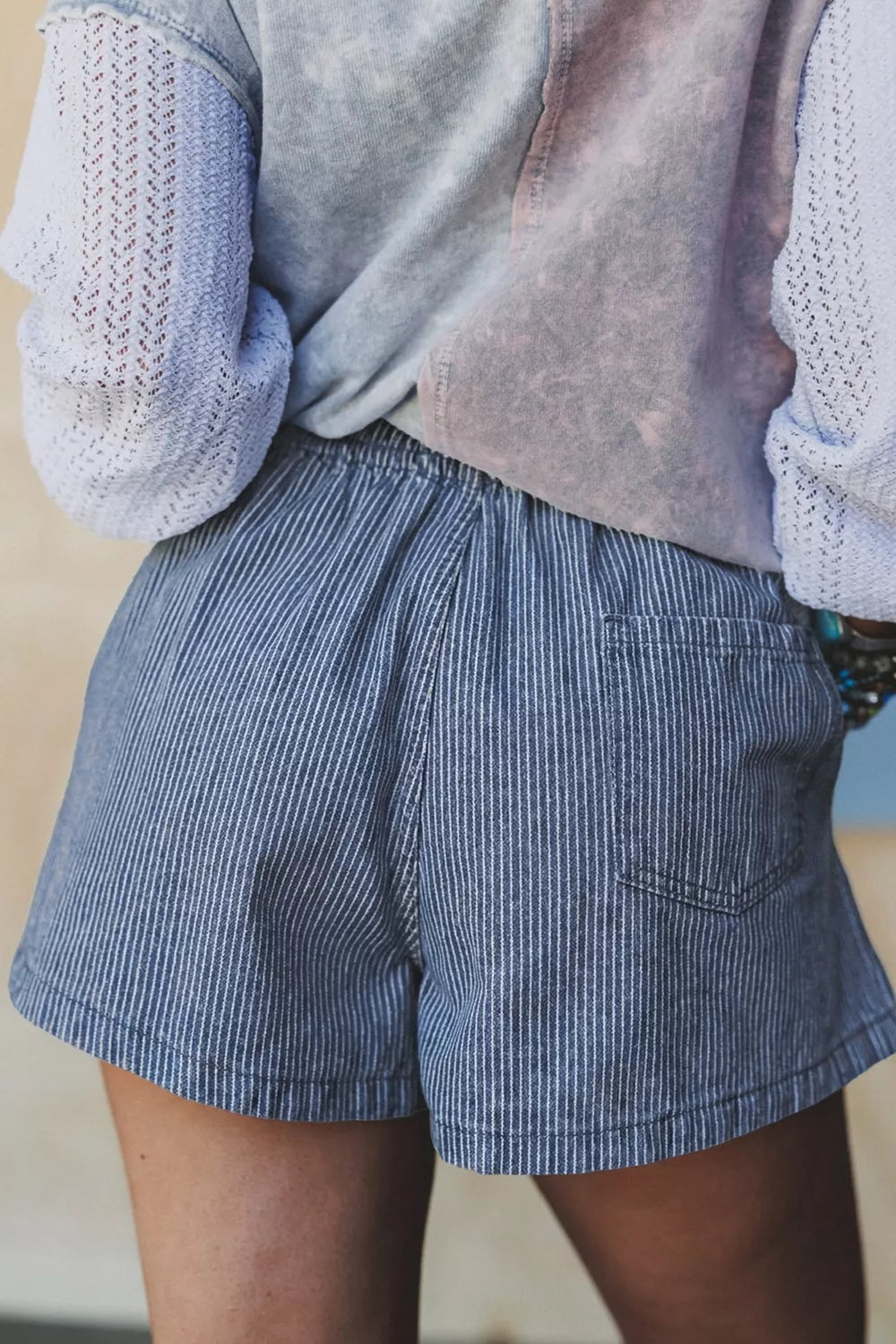 Back view of stylish drawstring denim shorts striped, showcasing breathable fabric and practical pockets.