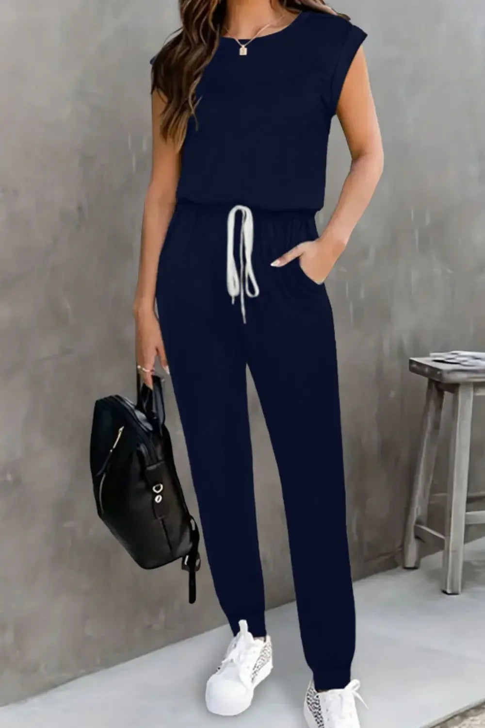 EmpowerEase Sleeveless Drawstring Jumpsuit in navy, featuring a drawstring waist and sleeveless design.