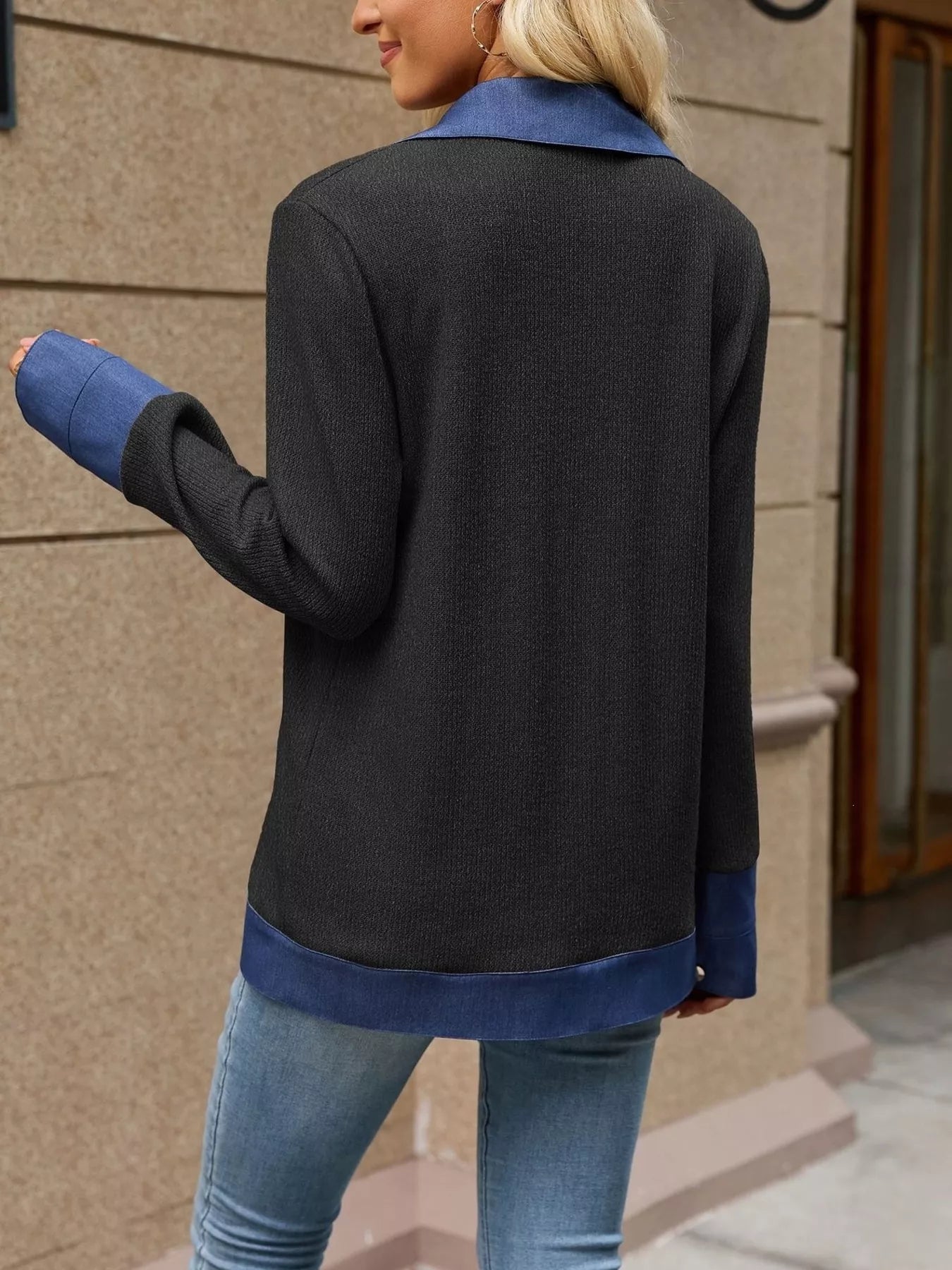 Woman wearing a black contrast denim lapel jacket, showcasing the stylish back view with blue accents.