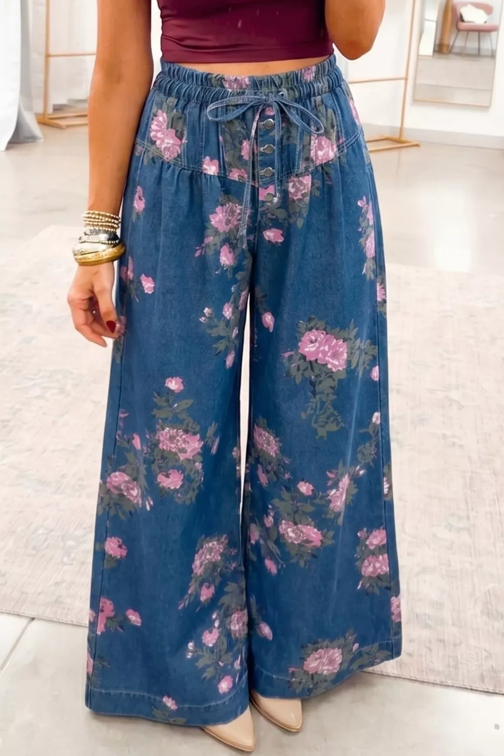 Floral Wide Leg Jeans with pink floral design, featuring a drawstring waist and wide-leg fit for a stylish look.