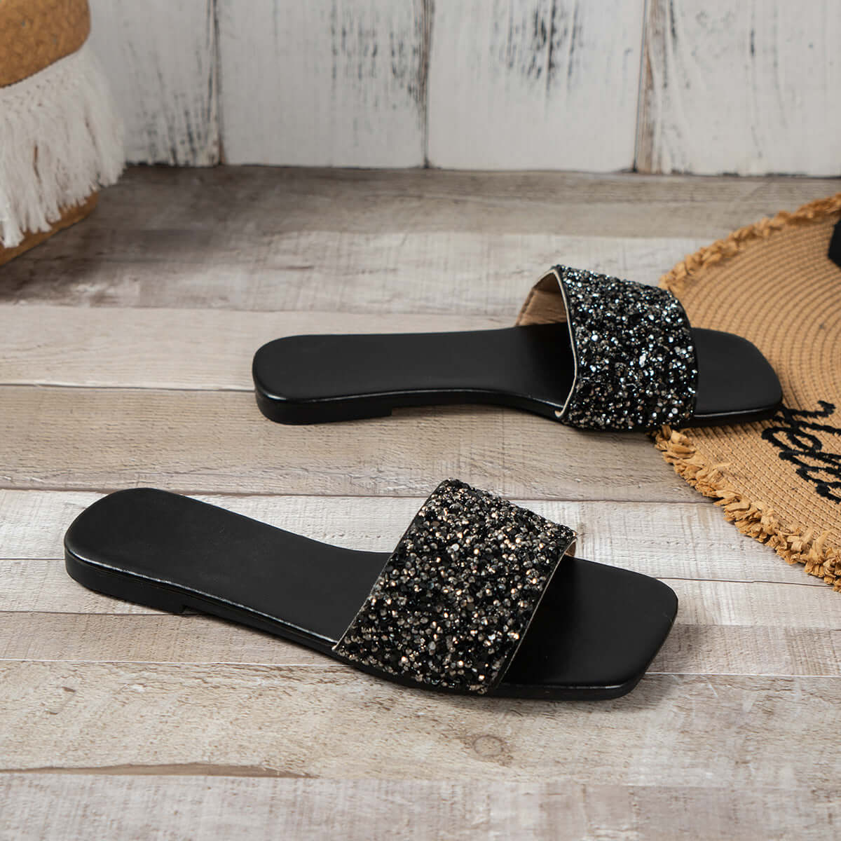 Stylish women's open toe sandals with rhinestone detail on black strap for added glam and comfort.