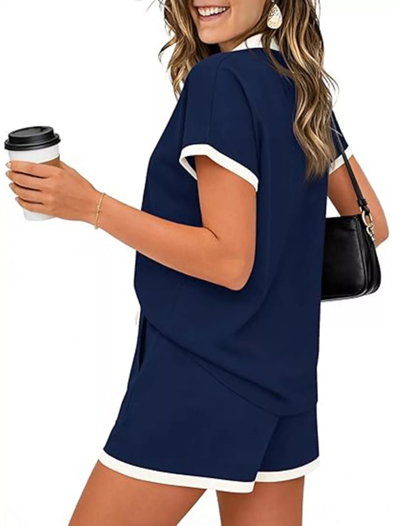 Short sleeve polo set featuring a drawstring and pocketed shorts, worn casually with a coffee in hand.