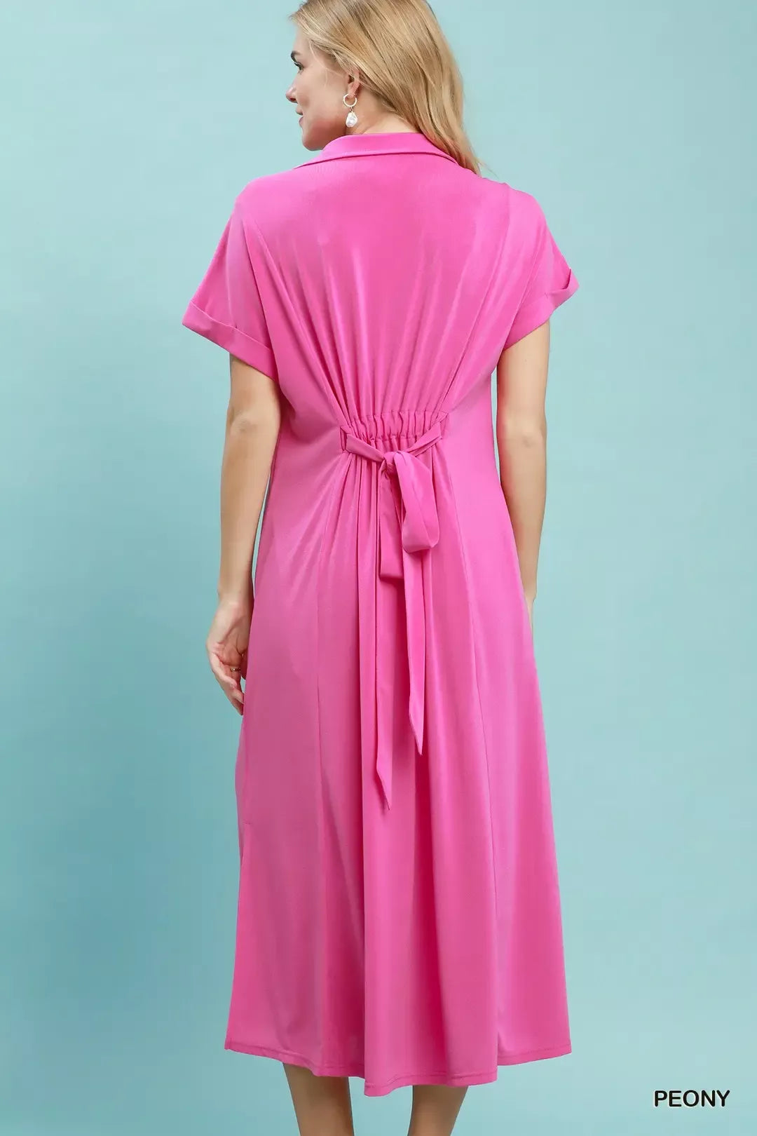 Back view of a casual midi dress belted in pink with a polished collared neck, showcasing its comfortable style.