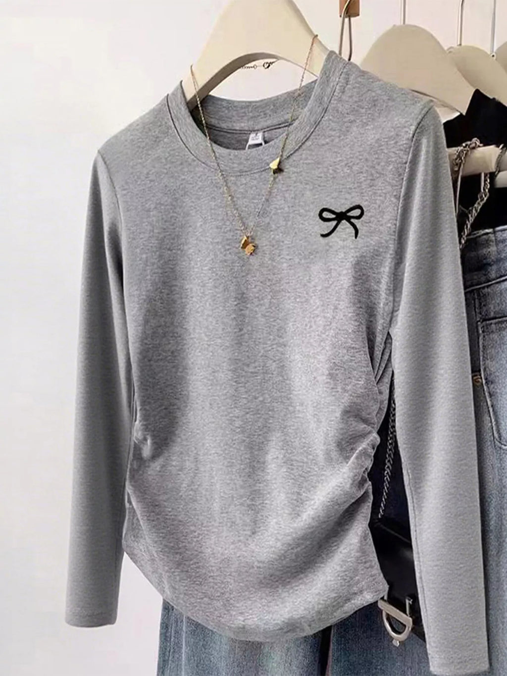 Cute Grey Bow Long Sleeve T-Shirt – Adorable Women’s Casual Top displayed on a hanger with a bow detail.