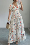 Woman wearing a floral dress for women, pleated maxi dress, showcasing its elegant design and colorful floral patterns.