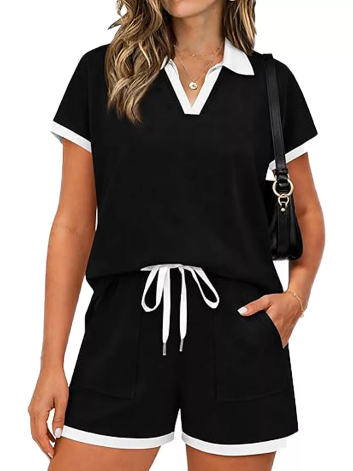 Short sleeve polo set featuring a black top and shorts, designed with a drawstring and pockets, perfect for casual wear.