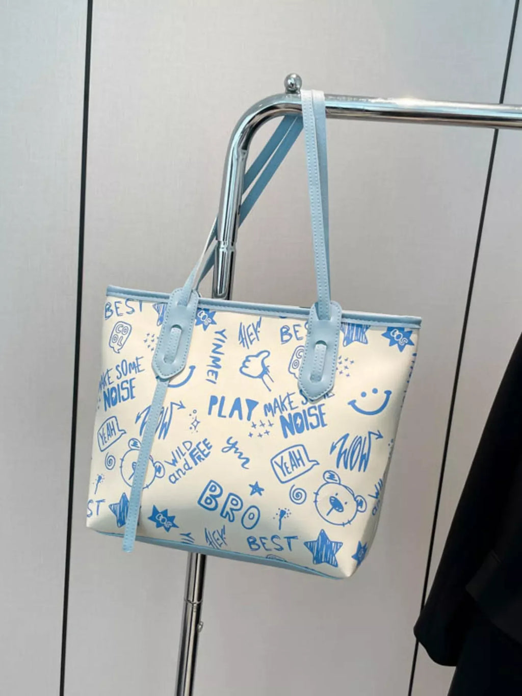 Graffiti Print Tote Bag – Large Canvas Shoulder Bag for Women hanging on a display, featuring colorful graphics and stylish design.
