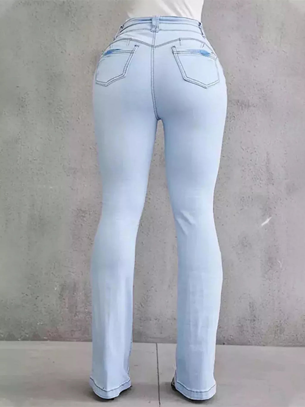 Plus size flare denim showcasing a light wash, emphasizing a stylish and comfortable fit from the back.
