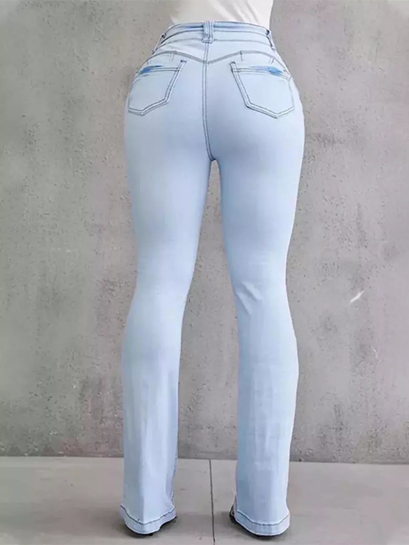 Plus size flare denim showcasing a light wash, emphasizing a stylish and comfortable fit from the back.