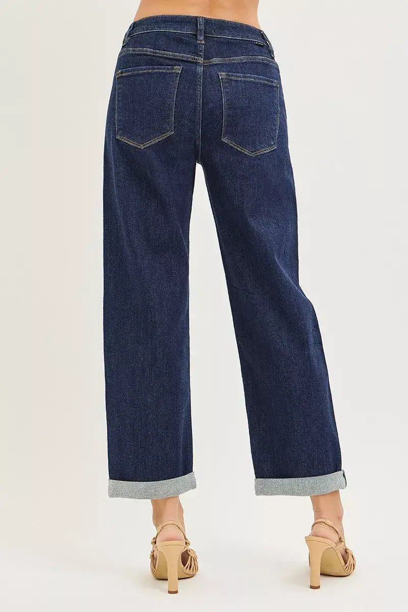 Woman wearing slouchy cropped boyfriend jeans with cuffed hem, showcasing the relaxed fit and styling.