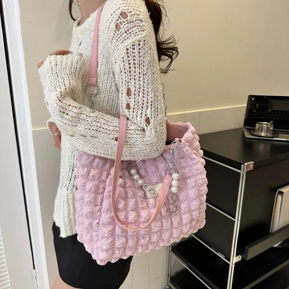 Confidence Carry Bubble Textured Tote Bag being carried by a person wearing a knitted sweater.