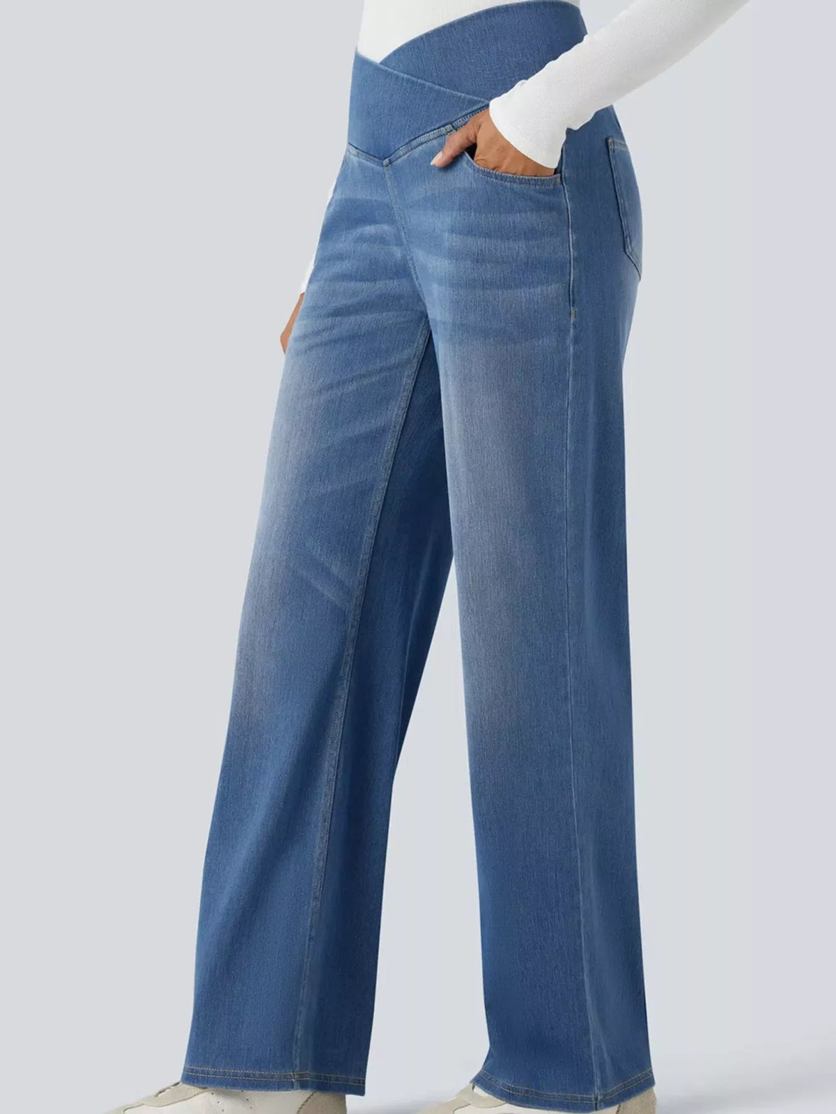High-waisted crossover jeans featuring a unique crisscross design and flattering high waist with a stylish washed finish.