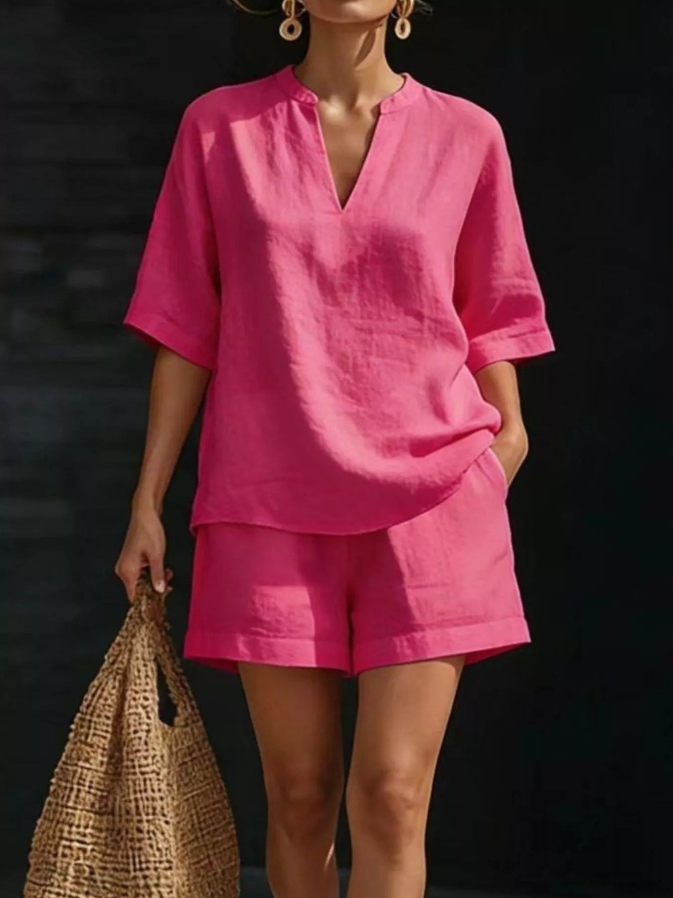Bright pink plus size two-piece shorts set featuring a notched half sleeve top and pockets.