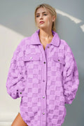 Model wearing a Fuzzy Button Up Checkered Shacket in lavender, showcasing cozy style with a chic checkered pattern.