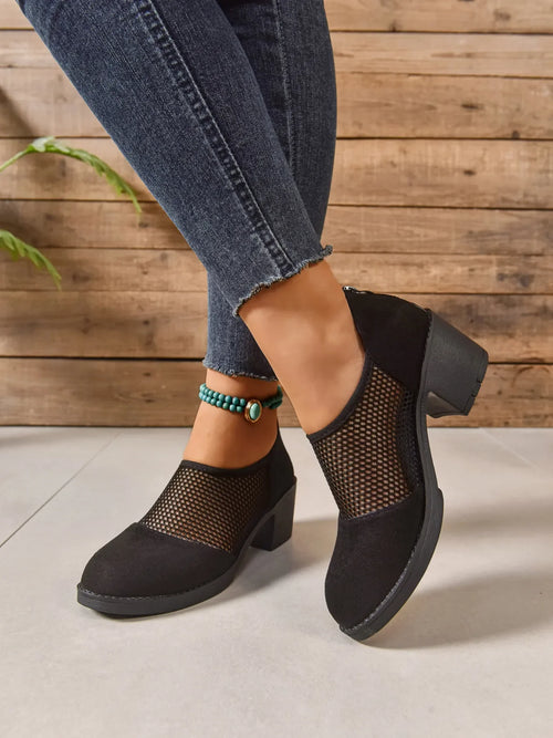 Black Mesh Panel Block Heel Pumps worn with denim, showcasing breathable mesh panel and sturdy block heel.