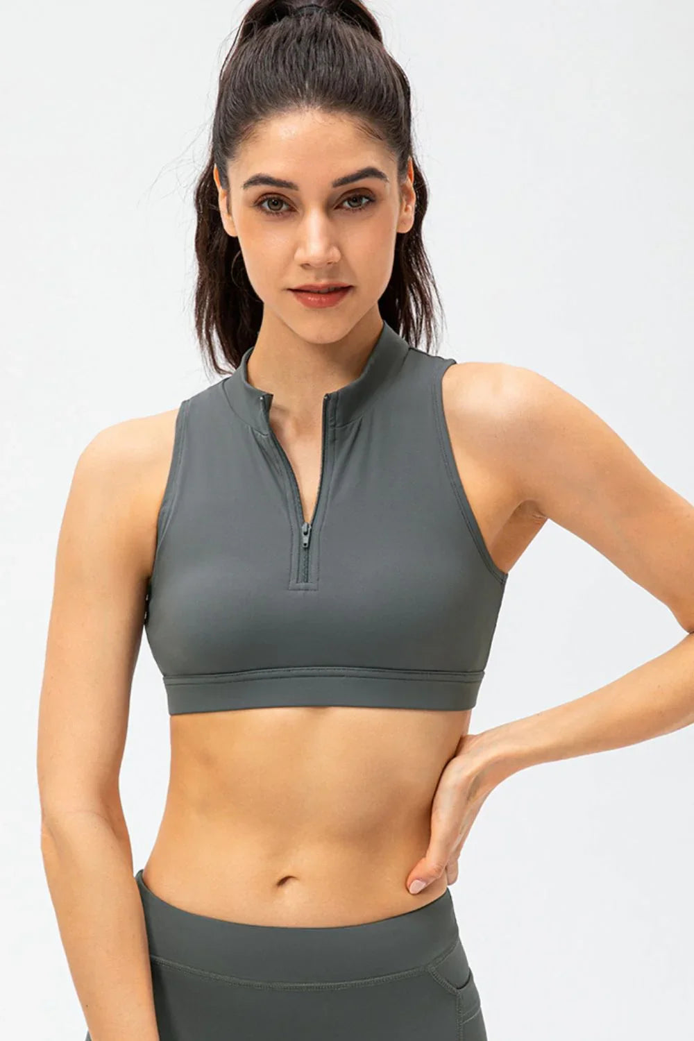 Full Size Cropped Cutout Back Zipper Front Active Tank Top worn by a model, showcasing its sporty design and comfortable fit.