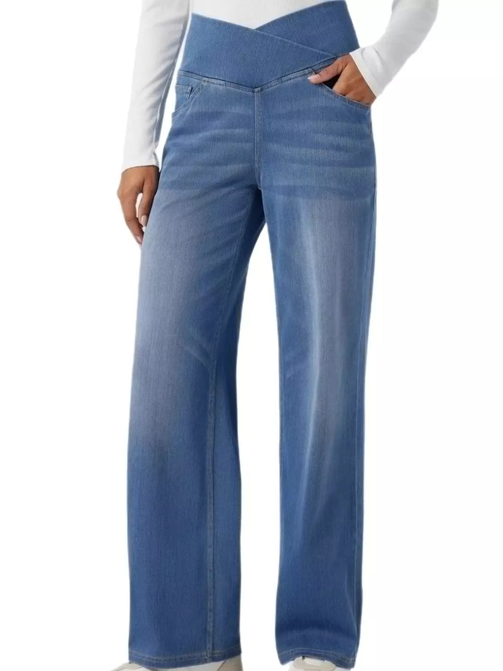 High-waisted crossover jeans in light wash with a unique crisscross waistband design and wide legs.
