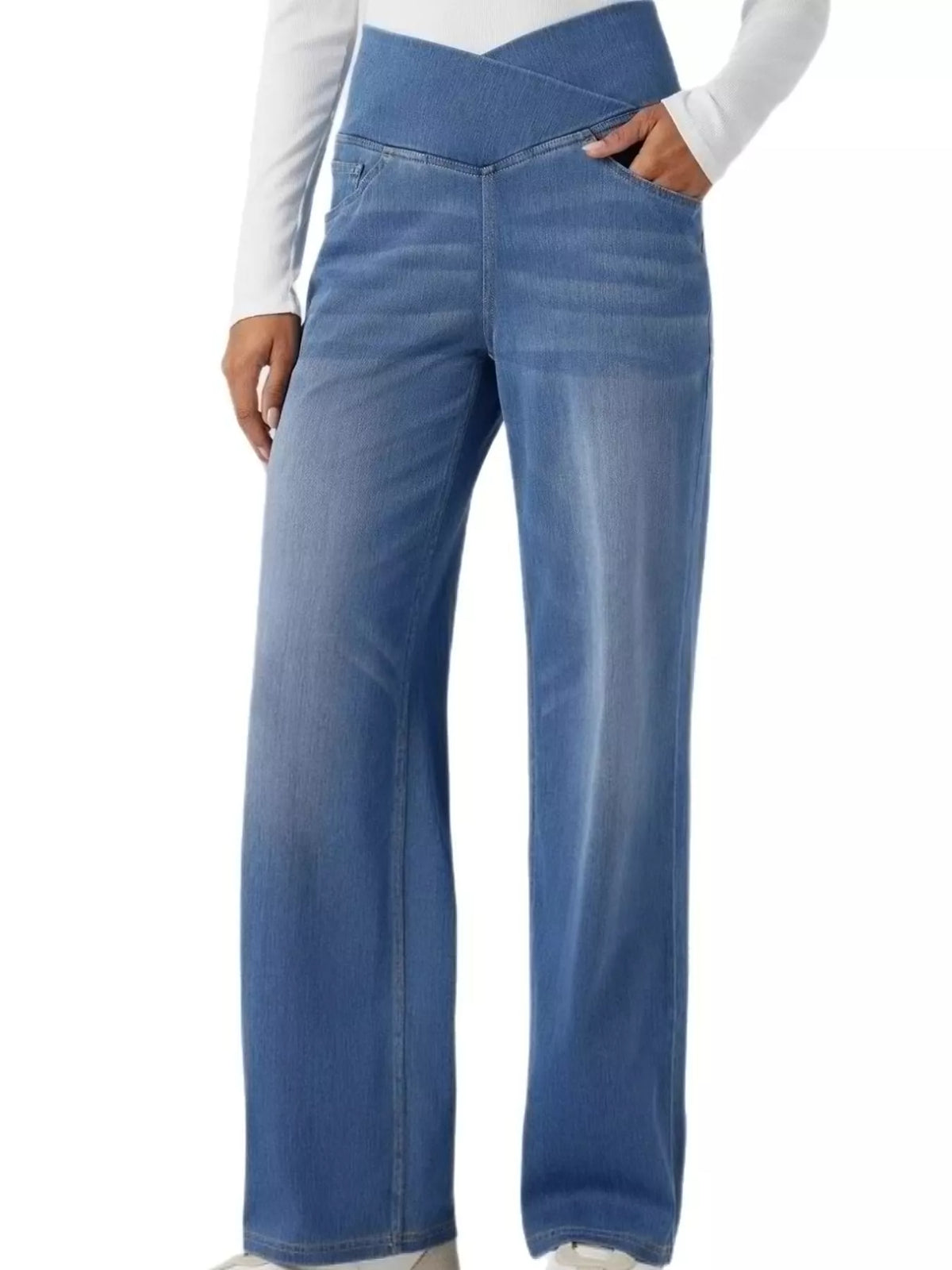 High-waisted crossover jeans in light wash with a unique crisscross waistband design and wide legs.