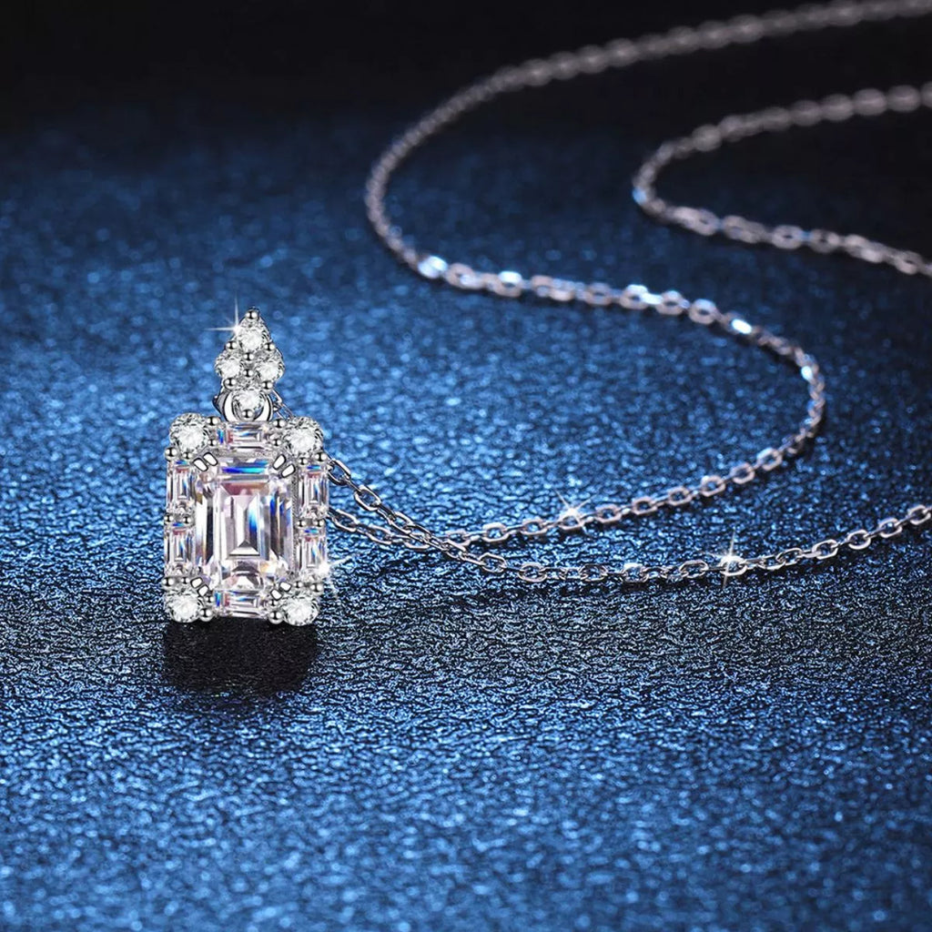 Moissanite jewelry pendant necklace showcasing a stunning 1 carat gemstone in 925 sterling silver on a blue background.