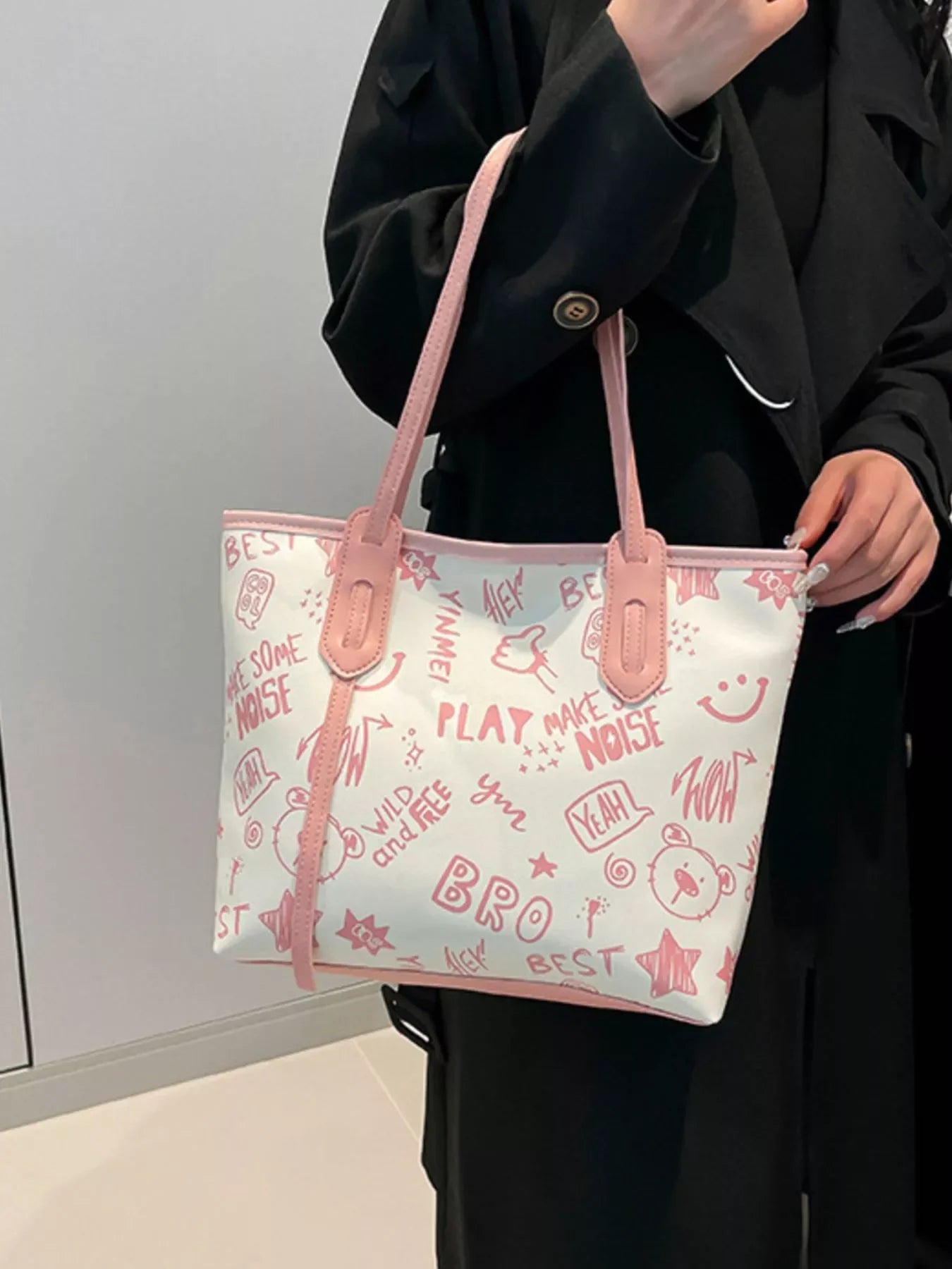 Graffiti Print Tote Bag – Large Canvas Shoulder Bag for Women held by a model showcasing vibrant street art graphics in pink.