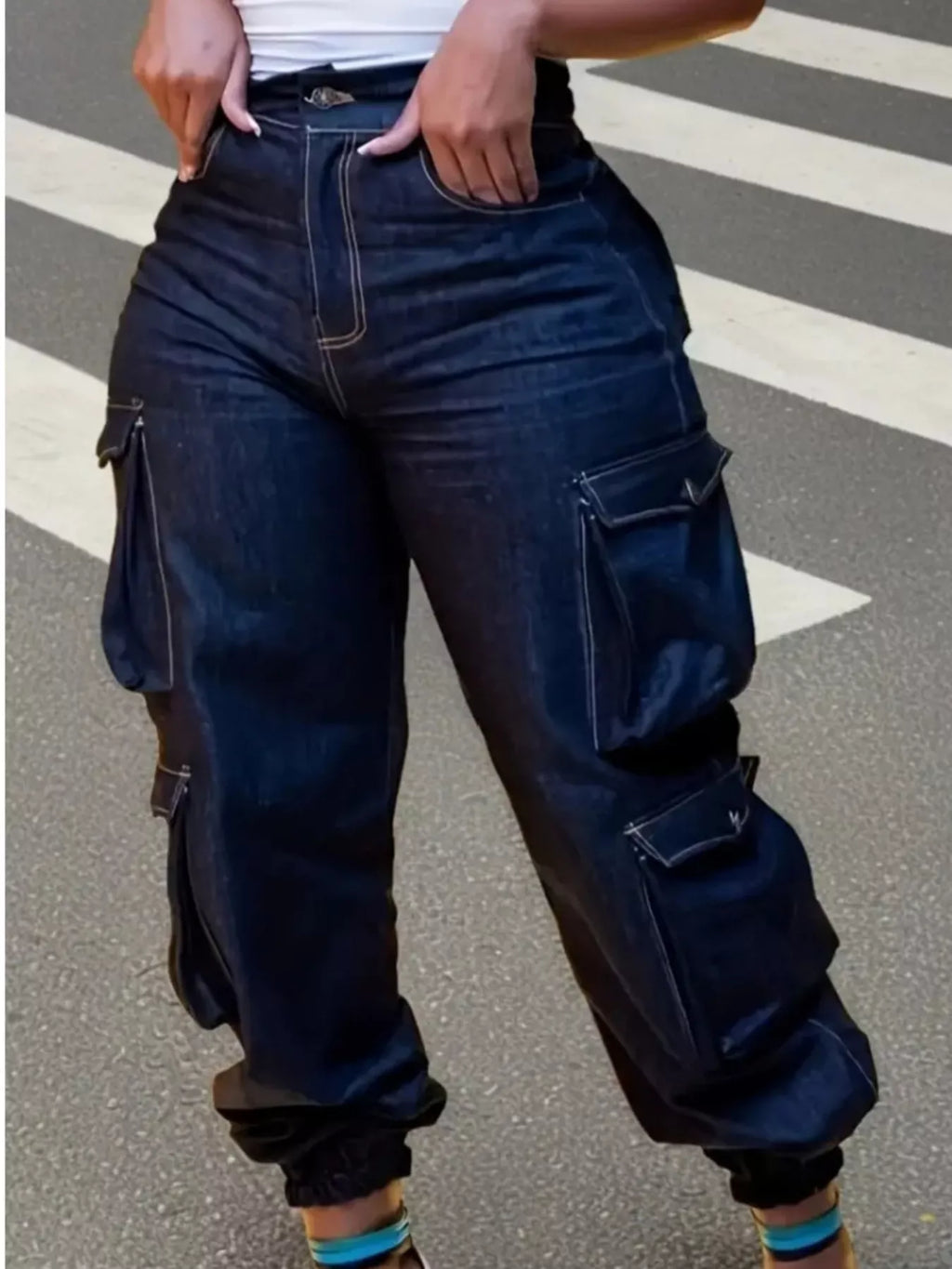 Fashionable plus size jeans in dark denim, featuring high-waisted design and cargo pockets, ideal for curvy figures.