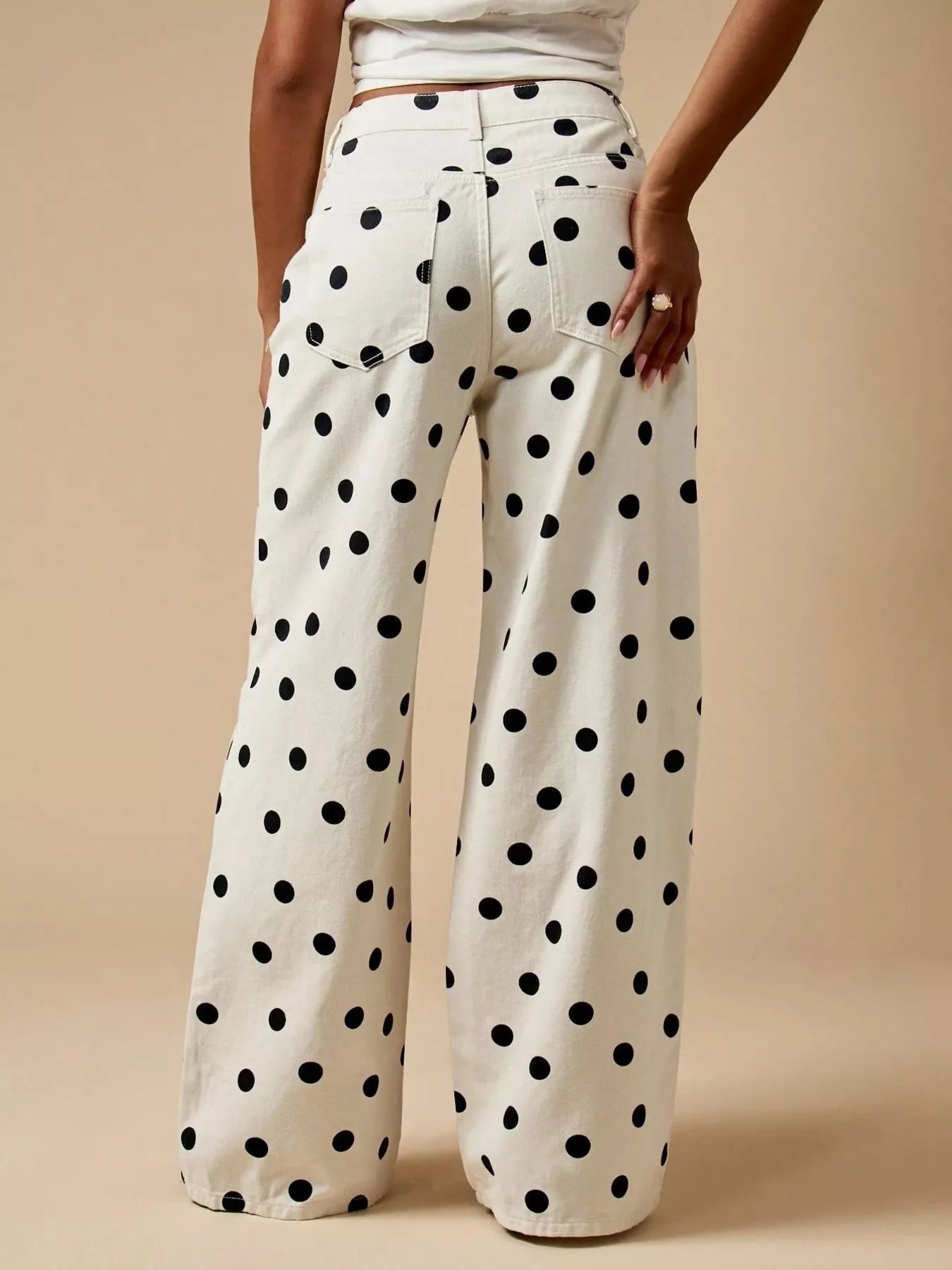 Trendy polka dot wide-leg jeans view from the back, featuring a pocketed design and comfortable fit.
