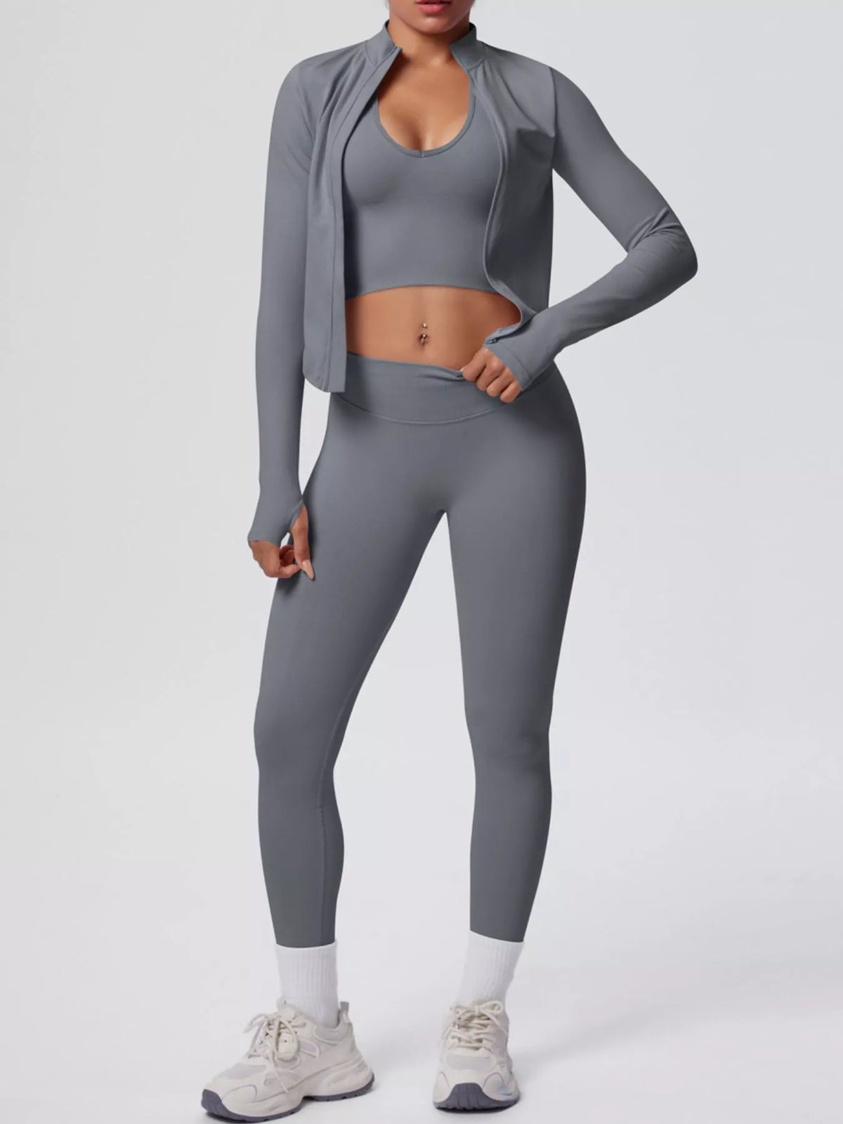 Stylish activewear set featuring a tank top, zip-up jacket, and leggings in gray color.