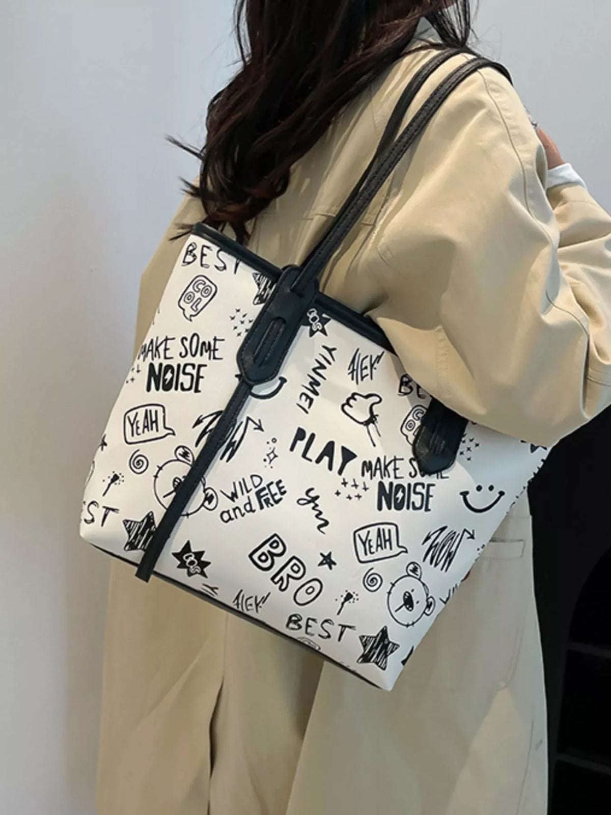 Graffiti Print Tote Bag – Large Canvas Shoulder Bag for Women being carried by a woman with stylish street art graphics.