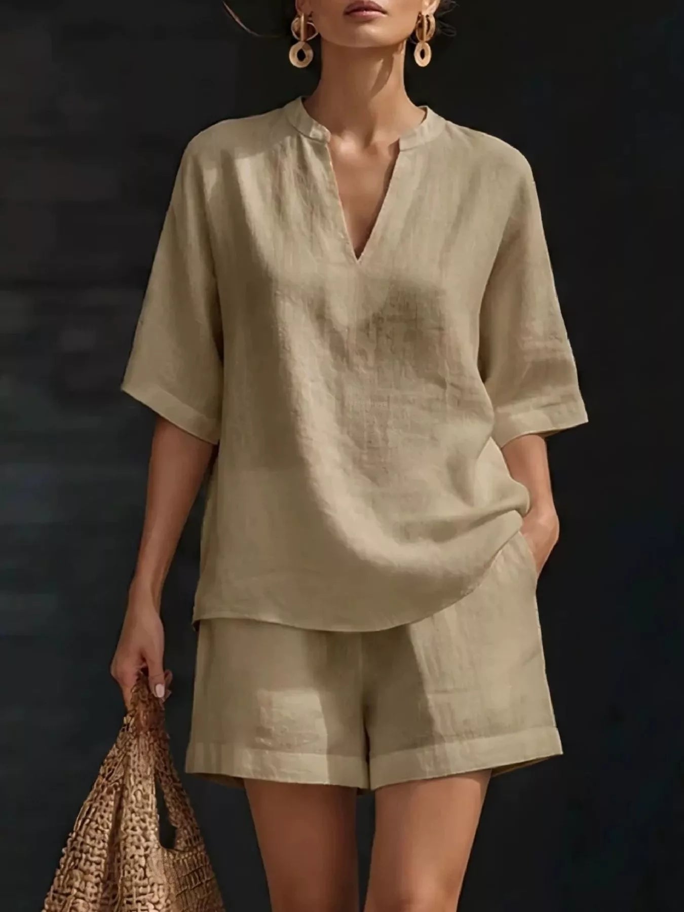 Fashionable woman in a plus size two-piece shorts set in beige, featuring a notched half sleeve top.