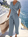 Full Size Surplice Short Sleeve Top & Pants Set – Women’s Plus Size Outfit (S–3XL) in a stylish setting by the sea.