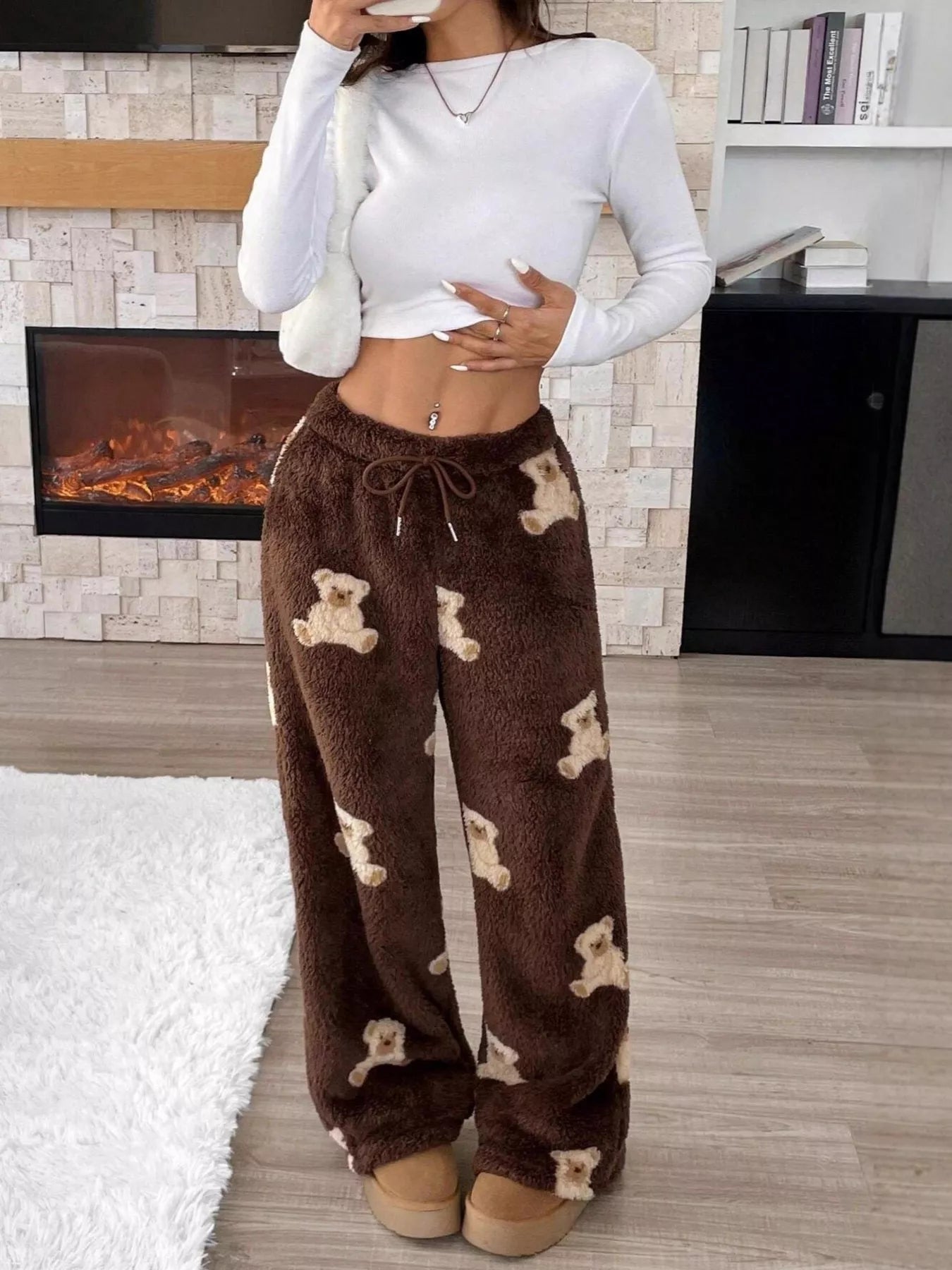 Teddy Bear Print Fluffy Pants displayed by a model in a cozy setting, combining comfort and playful style.