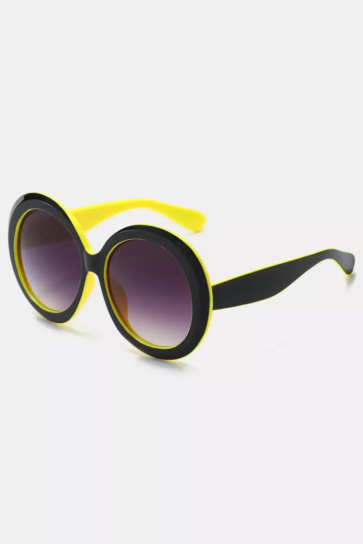 Oversized sunglasses for women with bold round frames in black and yellow, perfect for a fashionable look.