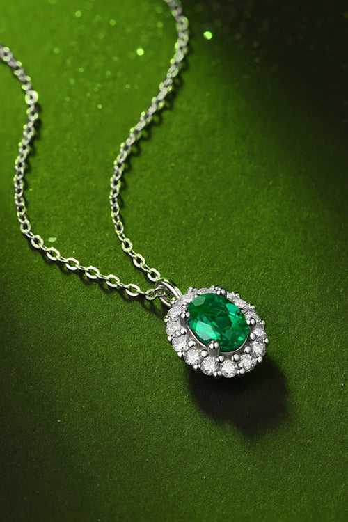 1.5 Carat Lab-Grown Emerald 925 Sterling Silver Necklace on a green background.