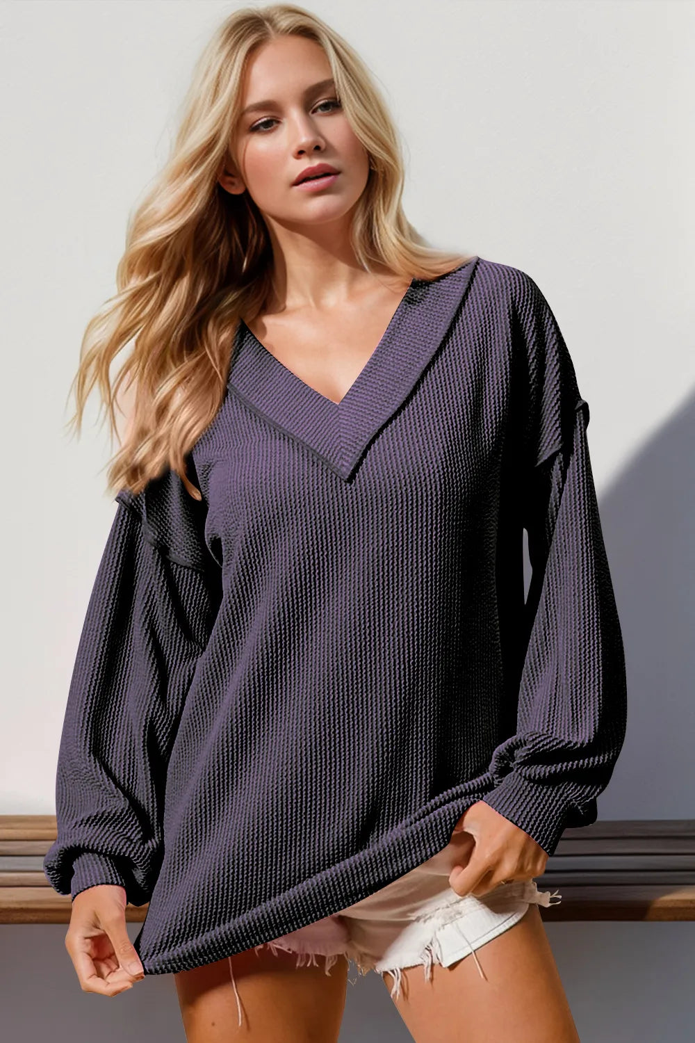 Double Take Exposed Seam Ribbed Textured V-Neck Long Sleeve T-Shirt worn by a model in a casual setting.