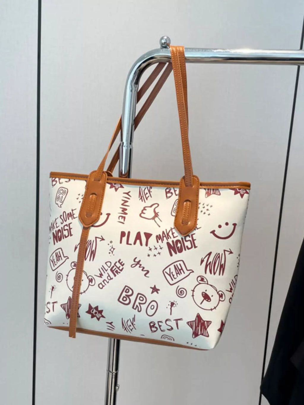 Graffiti Print Tote Bag – Large Canvas Shoulder Bag for Women displayed on a hanger with colorful street art design.