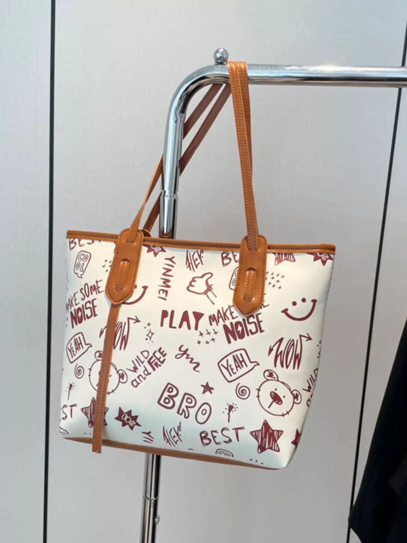 Graffiti Print Tote Bag – Large Canvas Shoulder Bag for Women displayed on a hanger with colorful street art design.